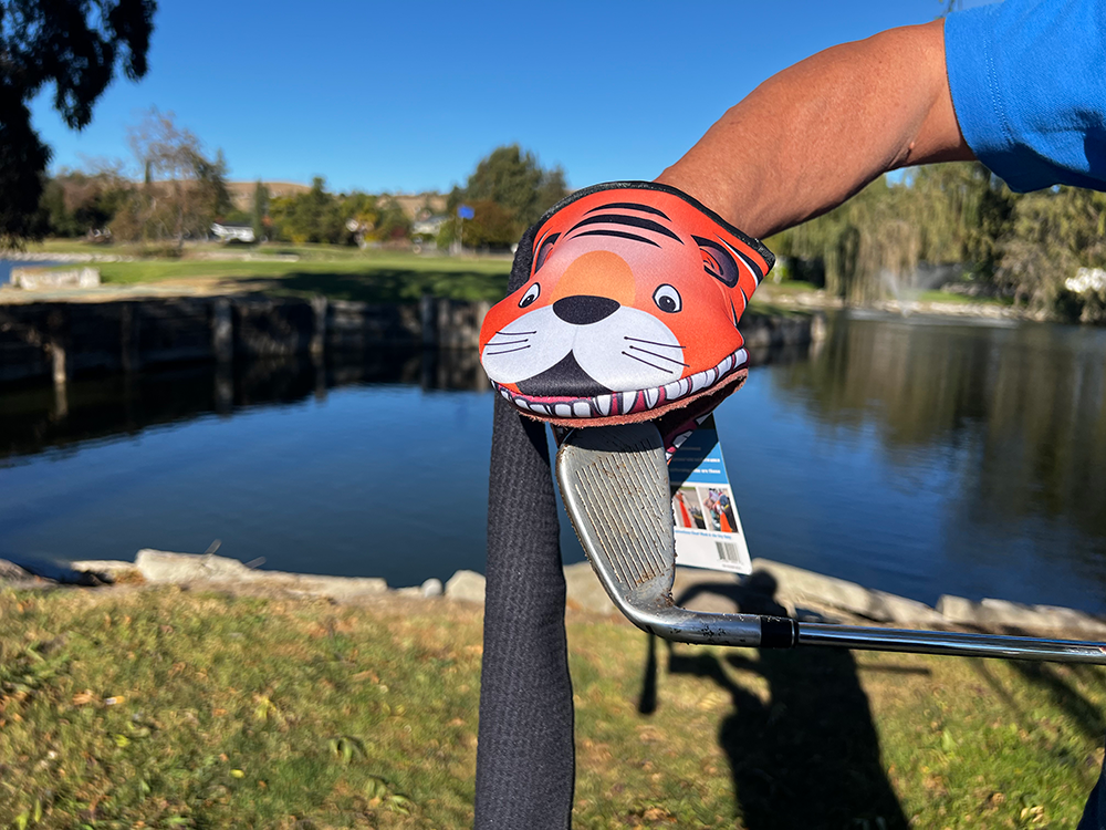 Image of Tiger product cleaning a dirty golf club iron